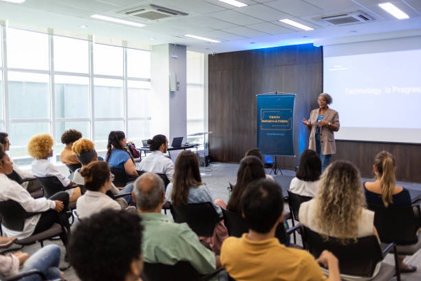 Middle-aged black woman giving lecture in auditorium